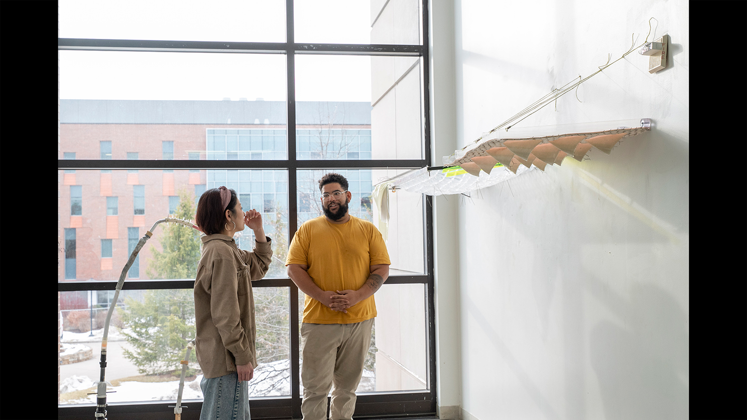 MFA candidate Marcia Liu chats with visiting artists Corey Pemberton.