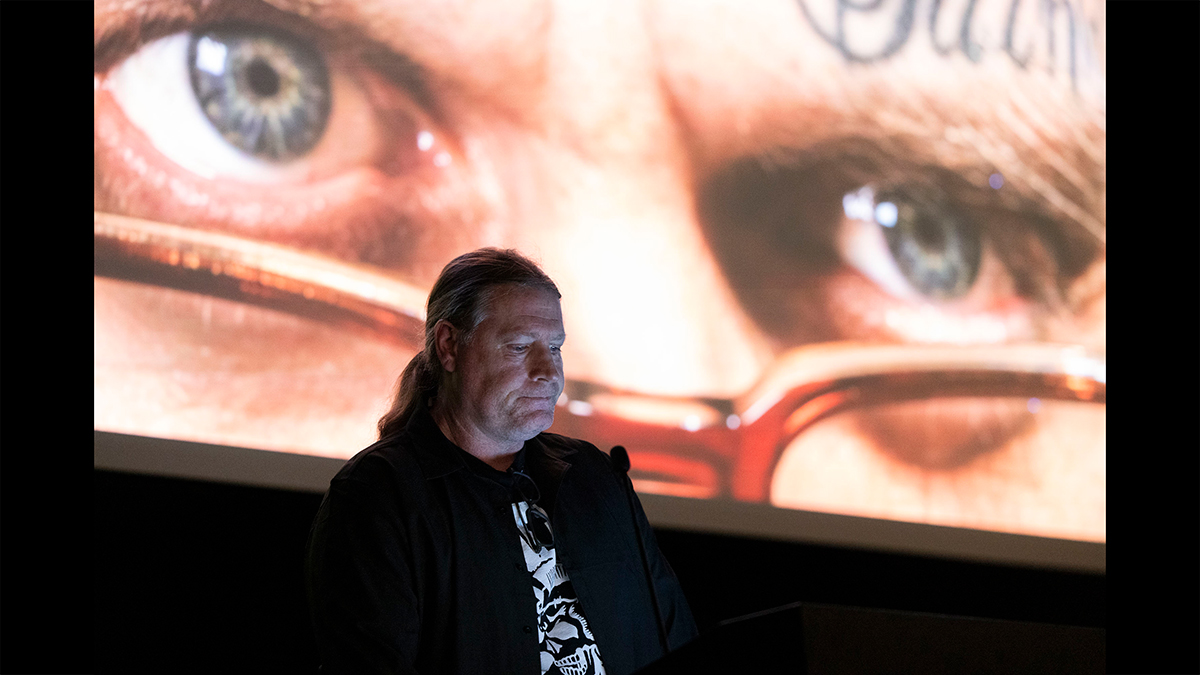 A student presents photos she took on a large projection screen.