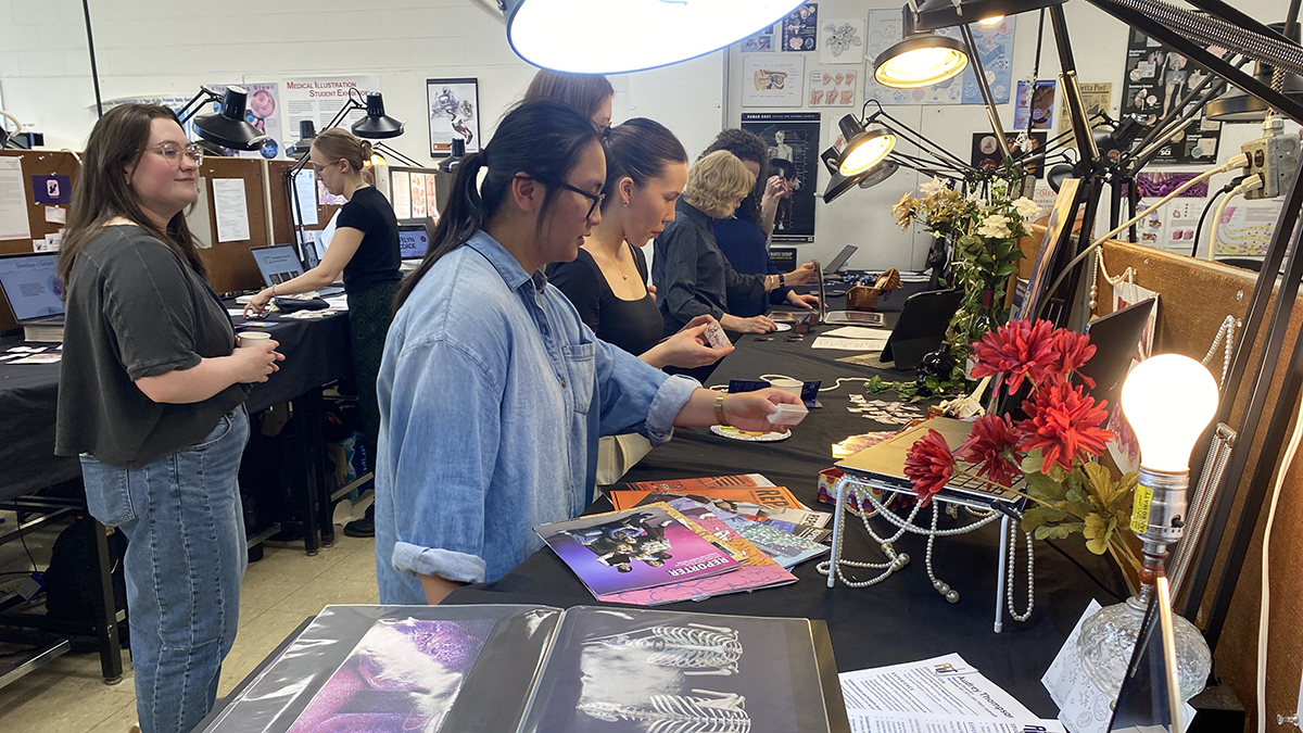 Visitors at RIT's medical illustration showcase.