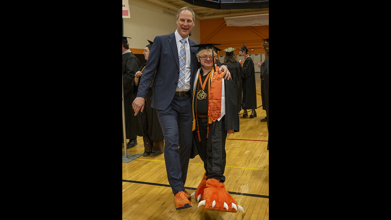 Dean Todd Jokl with student Lyle Lewis, who is wearing RITchie tiger claws for shoes.