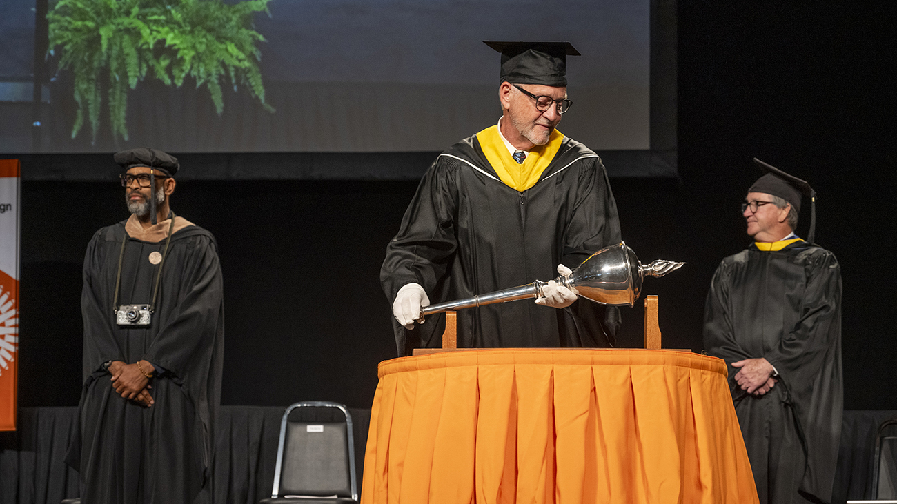 Michael Peres places the mace on a table.
