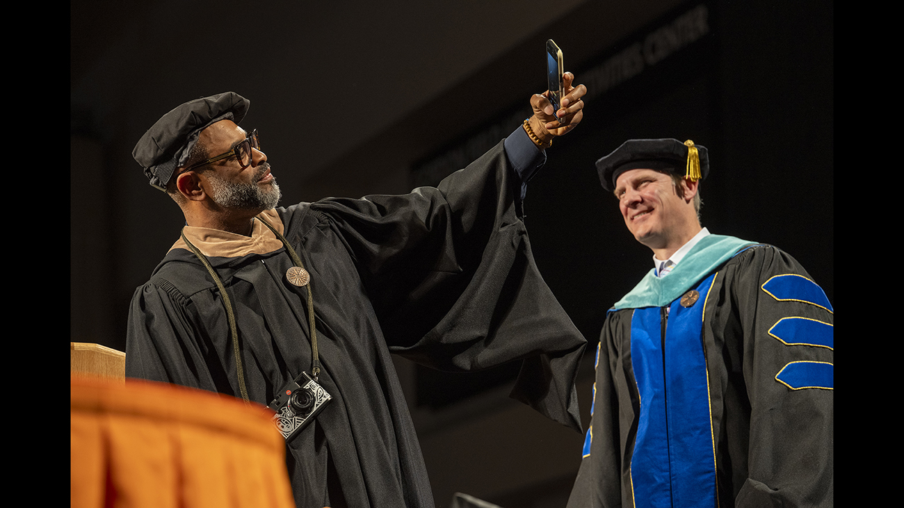 Kwaku Alston take a selfie on stage.