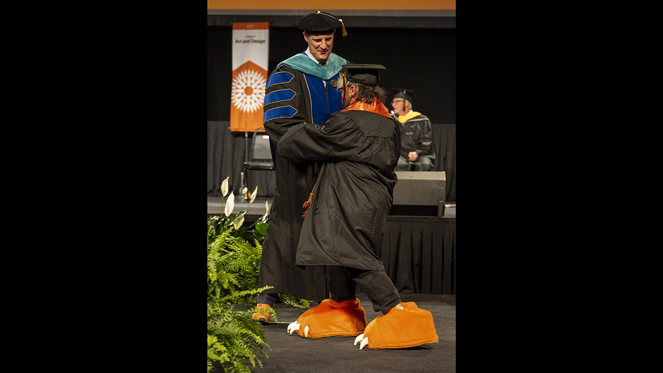 Dean Todd Jokl with student Lyle Lewis, who is wearing RITchie tiger claws for shoes.