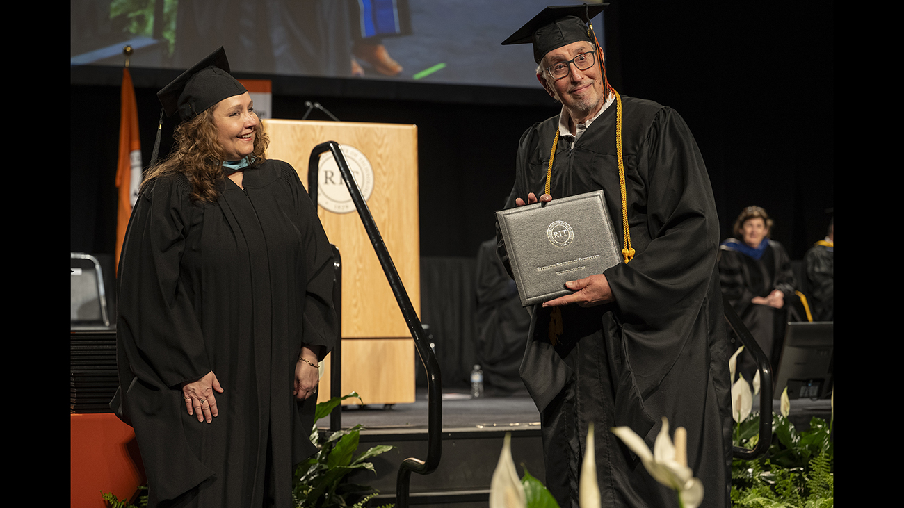Gary Stone '75 officially receives his degree 50 years after graduating.