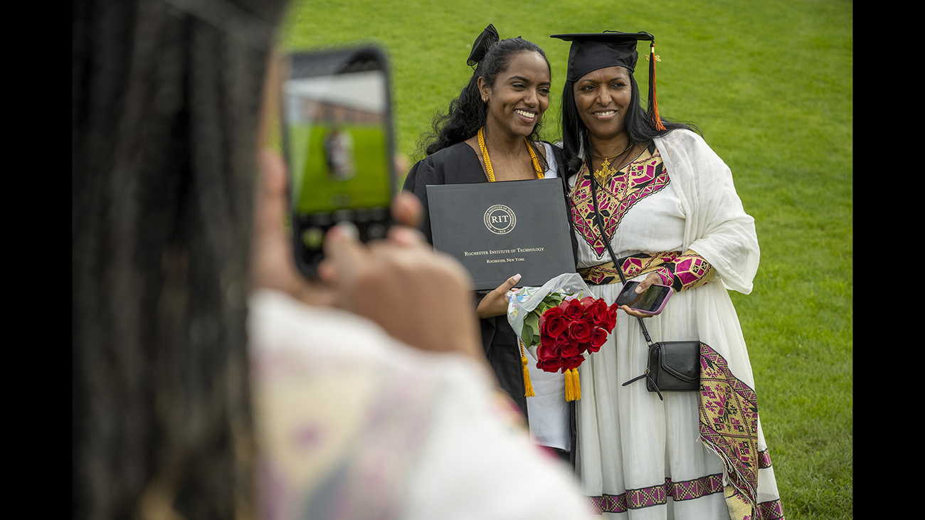 A mother and daughter have their photo taken.