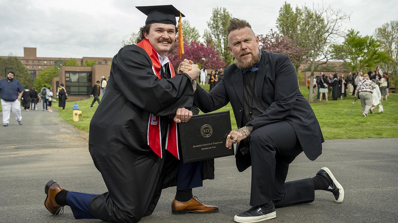 Faculty Clay Patrick McBride and a student embrace.