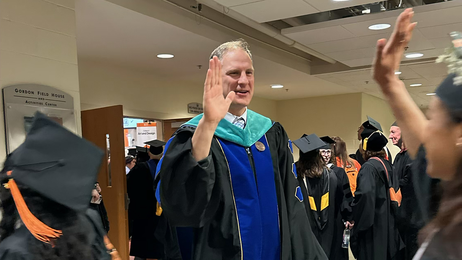 Dean Todd Jokl high fives a student.