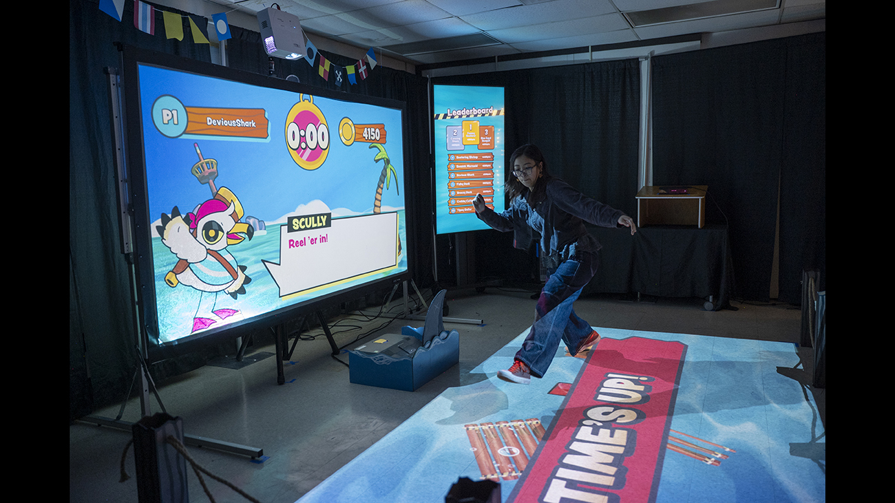 A user jumps on an interactive floor experience.