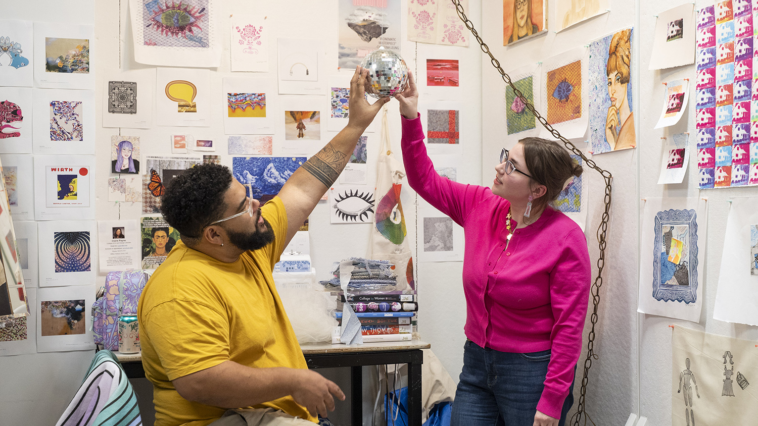 An MFA candidate smiles and talks with visiting artist Corey Pemberton.