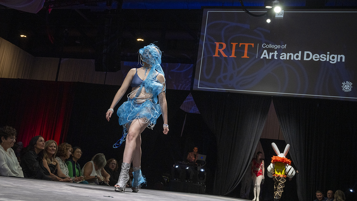A tudent showcases a Charrette creation on the Rochester Fashion Week runway.