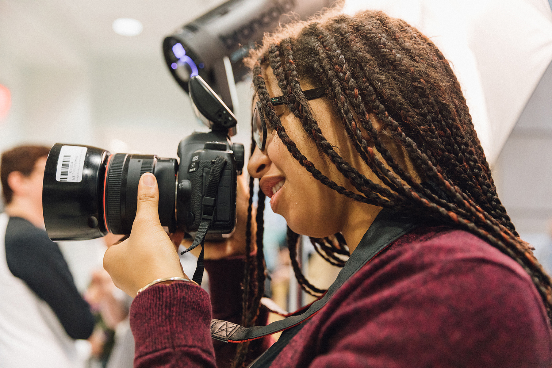 A student photograhs with a camera.