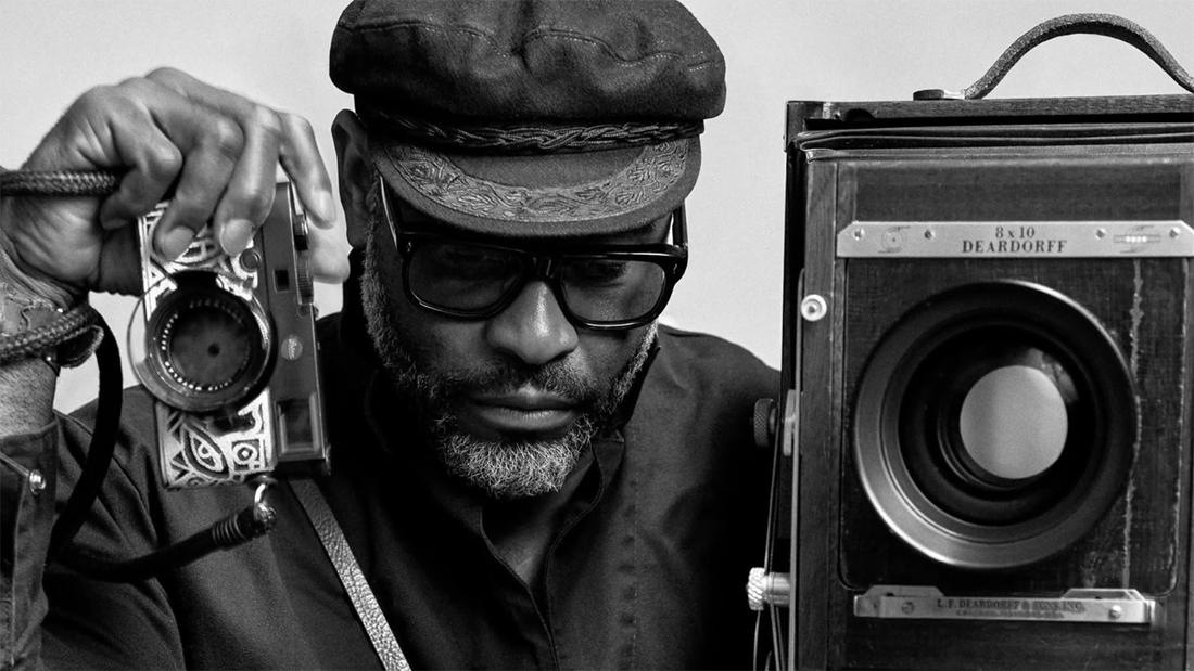 Kwaku Alston holding up cameras.