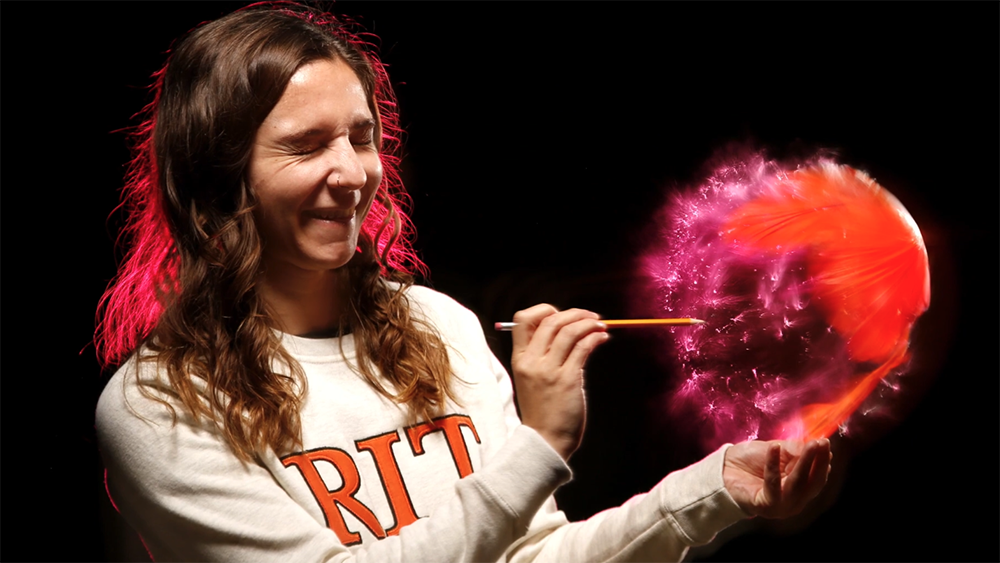 Teri Zgoda popping a balloon.