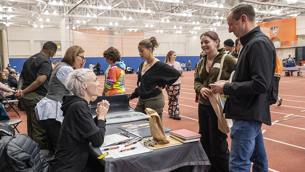Faculty speak with prospective students.