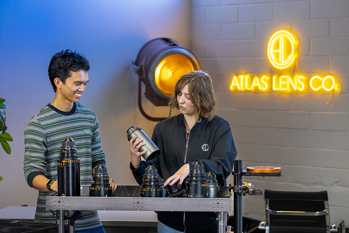 Students look at camera lenses.