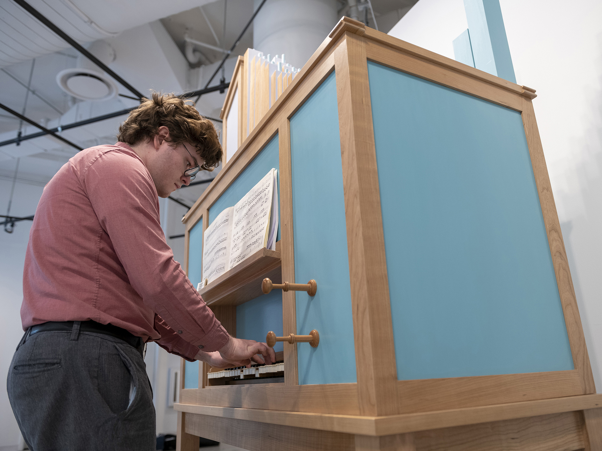 Student Kelly Cleveland plays the pipe organ he hand-crafted.