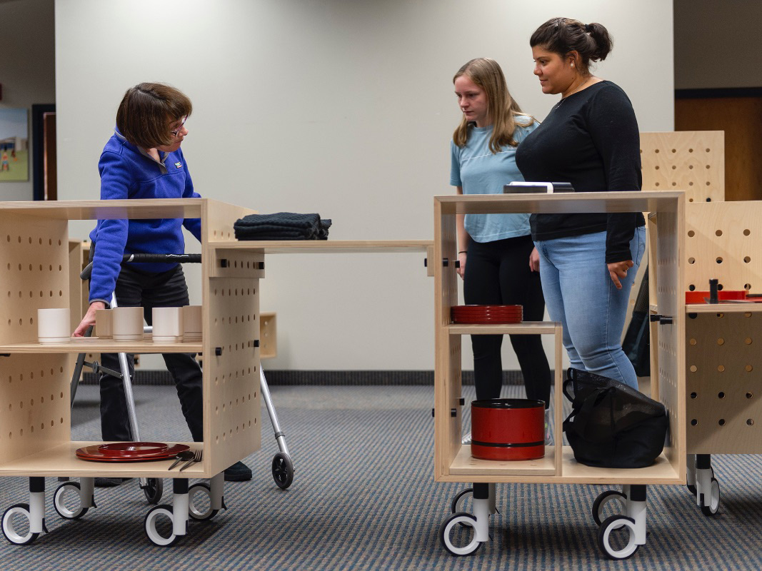 Students demonstrate the use of a mobile kitchen design.