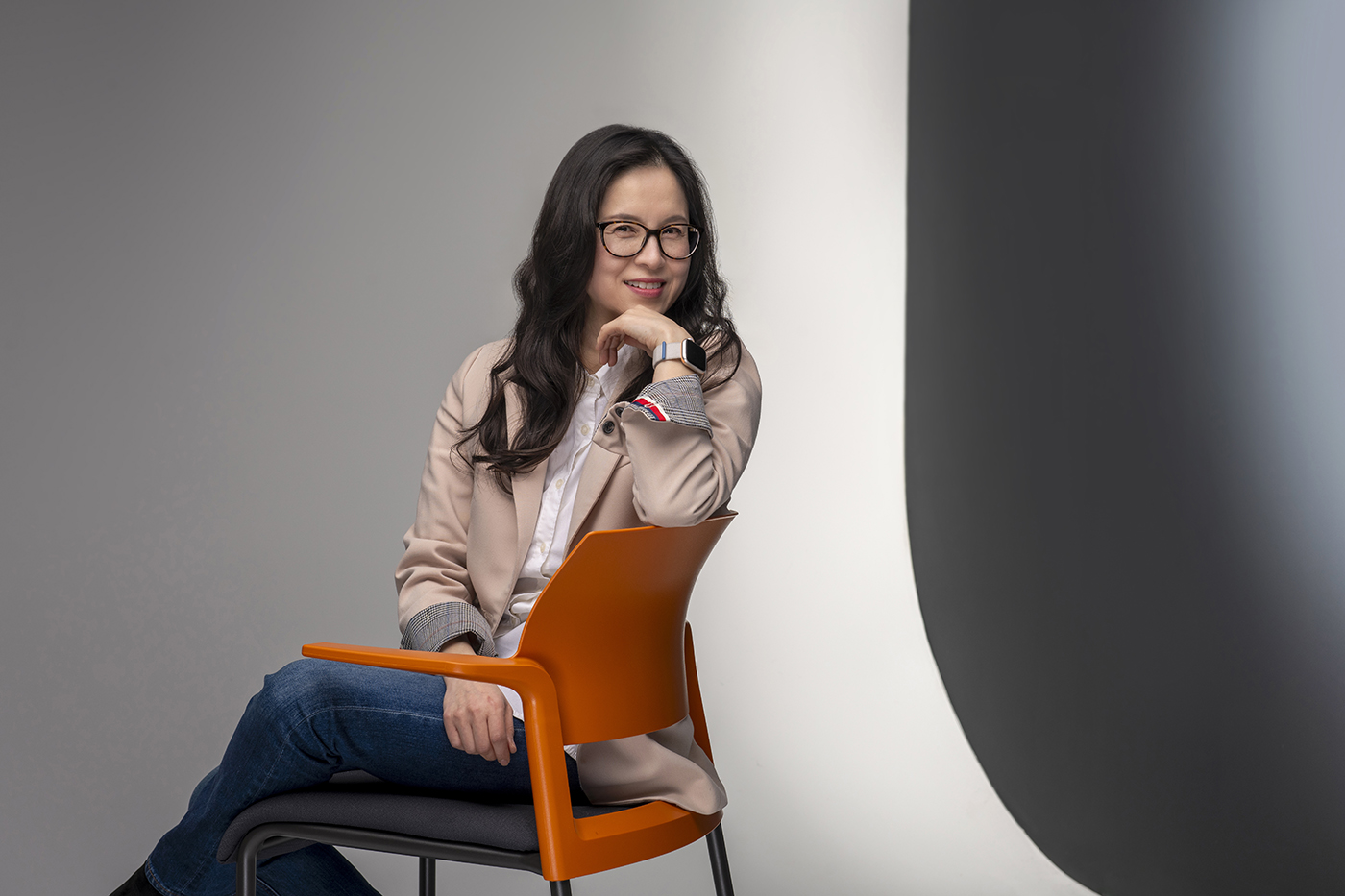 Hye-Jin Nae sits on a chair in a photo studio.