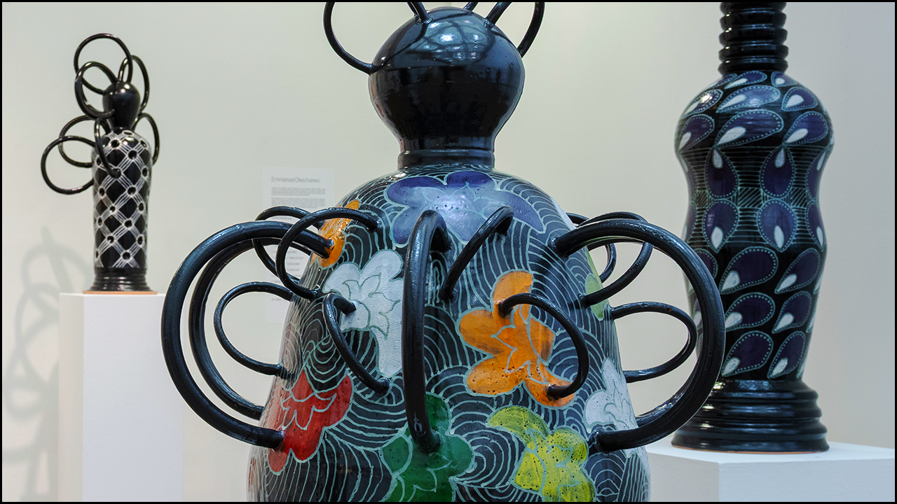A ceramic sculpture on a pedestal in a gallery.