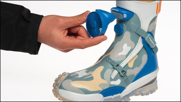 A fan being attached to a prototype looking shoe