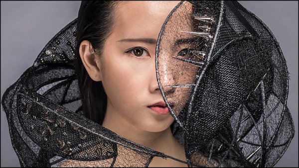 Girl with an artistic metal collar around her next and shoulders