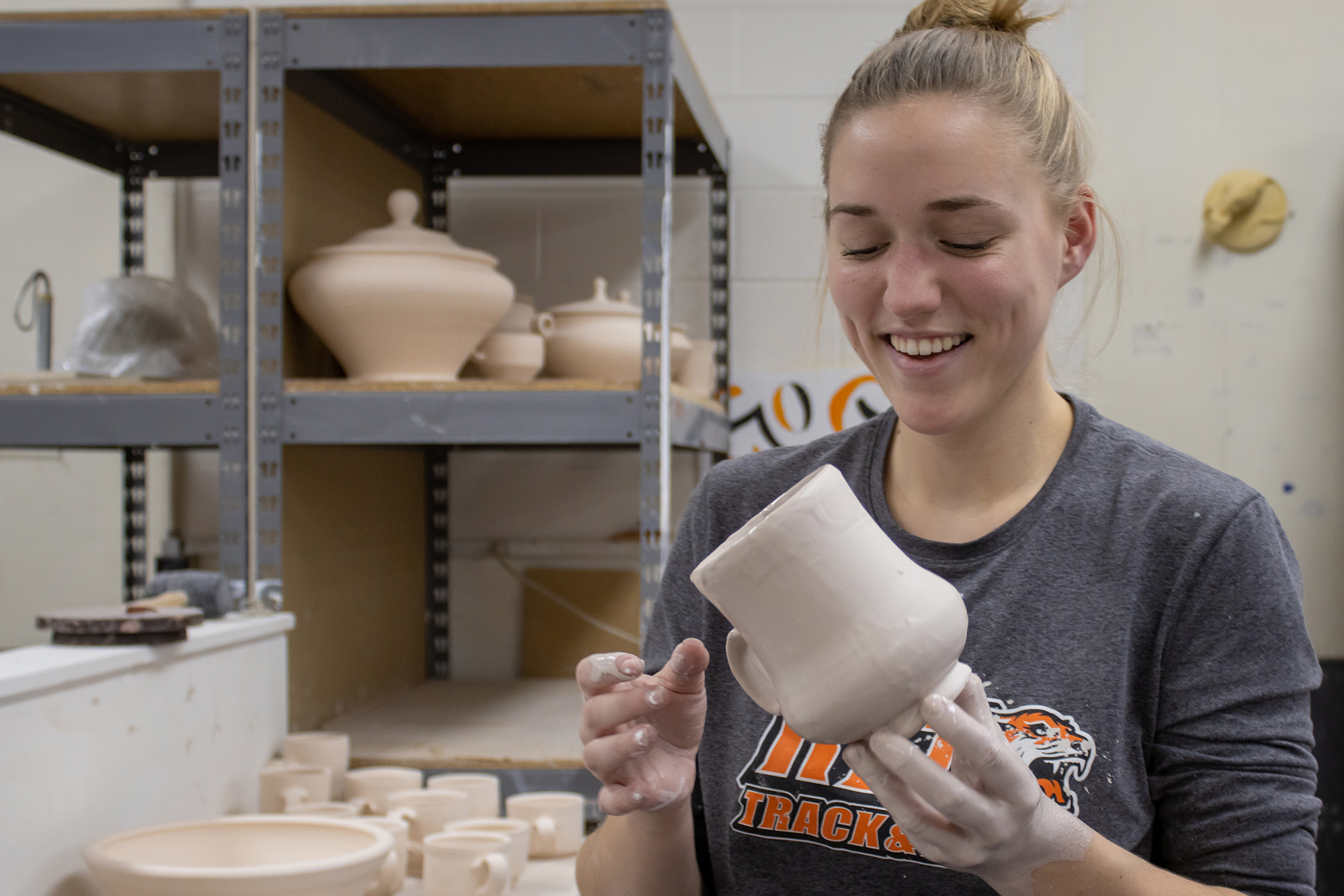 Marian Draper holds a cup she made.