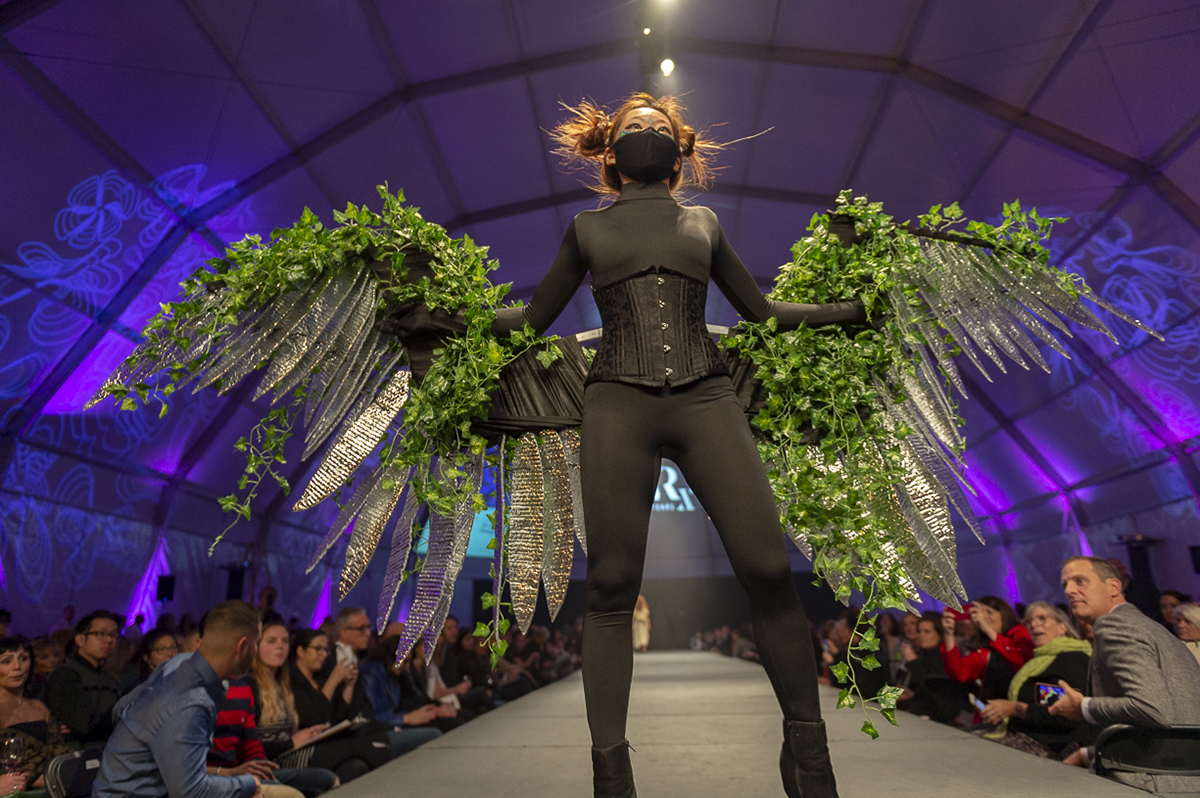 A student models her wearable wings design on the runway at a Fashion Week of Rochester event.