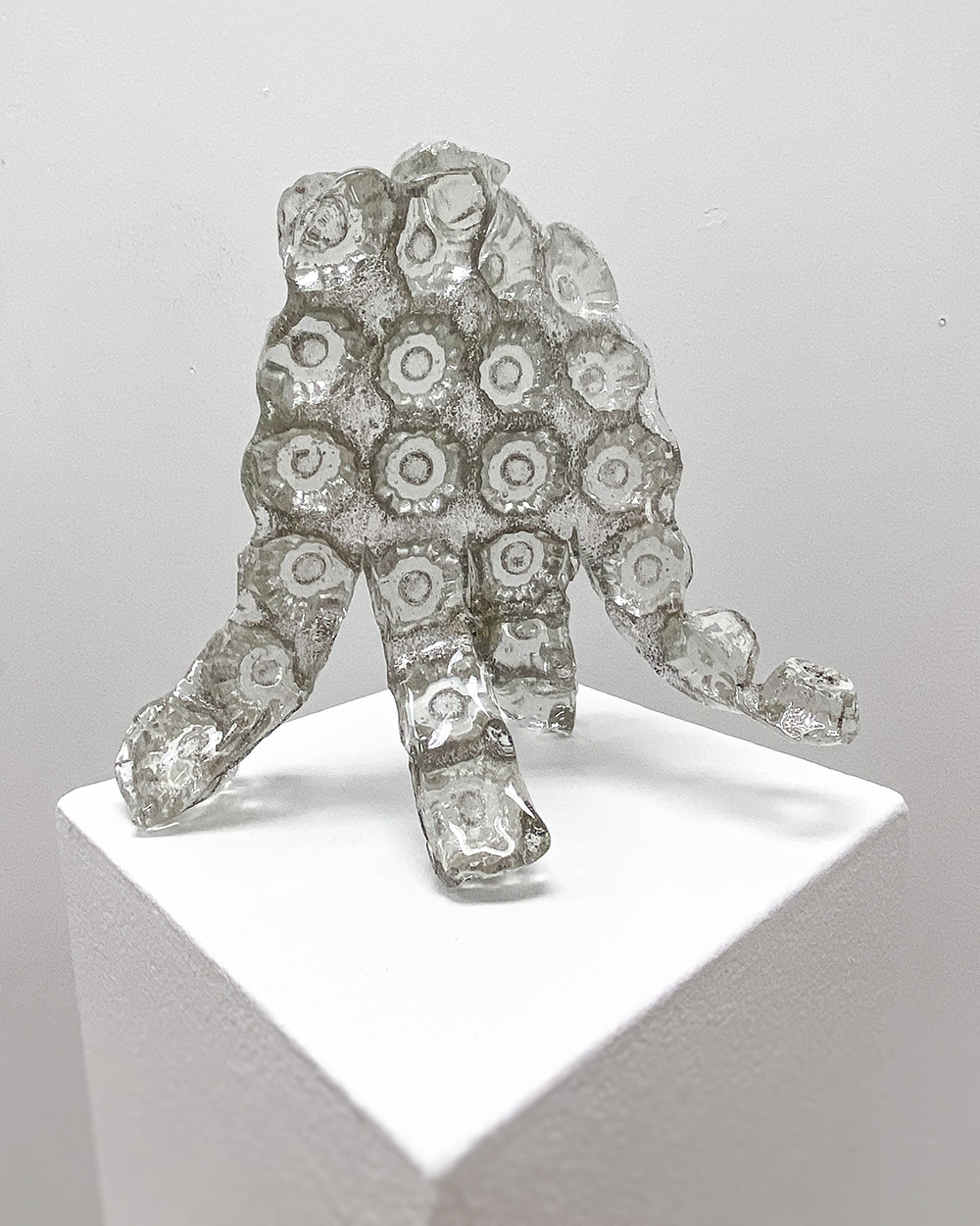 A glass sculpture that resembles a hand.