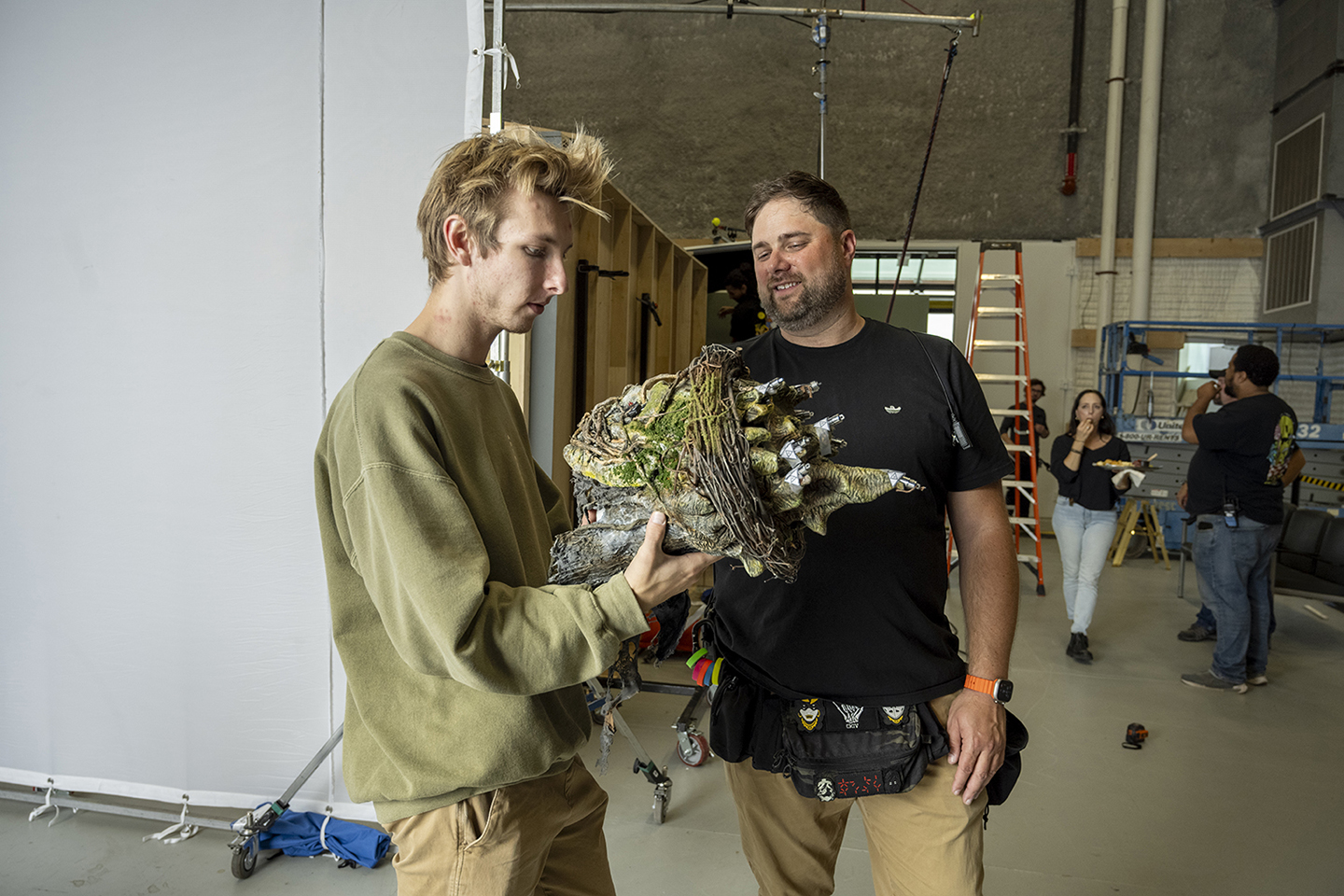Kendall Dirks and Phil Szrama look at a mask they are making visual effects for.