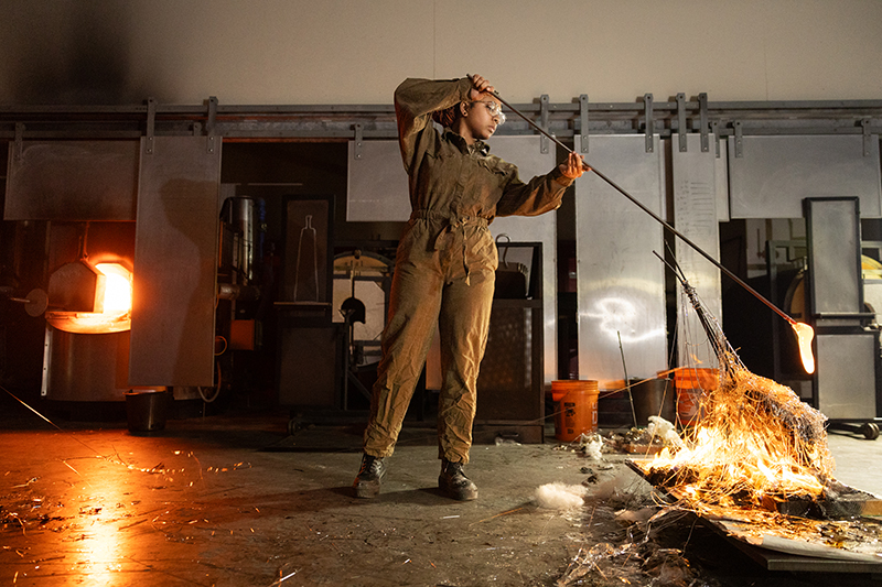 Spider Martins leads a performance in the glass hot shop.