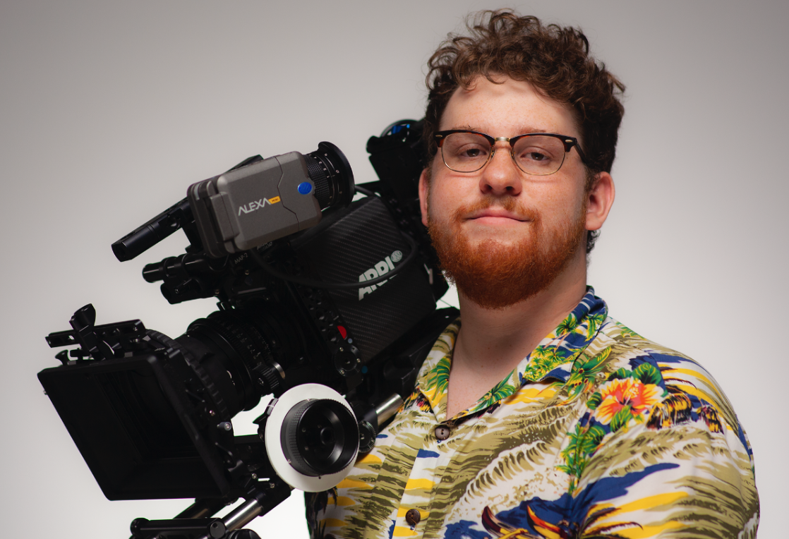 Student Simon Yahn holds a camera.
