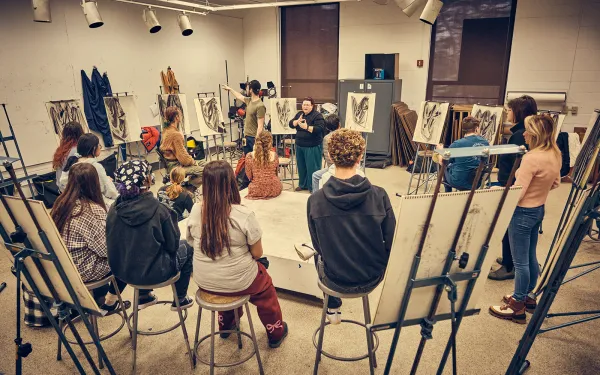 A large group drawing critique.