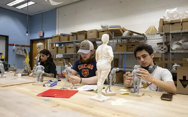 Students sculpt in a studio space.