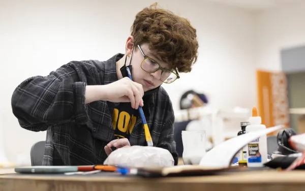 A student paints in the studio.
