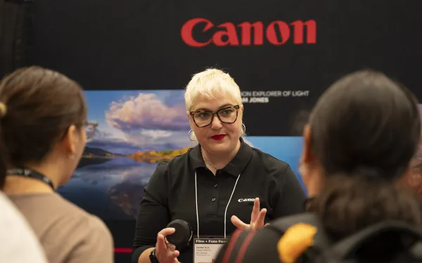 A Canon rep talks with conference attendees.