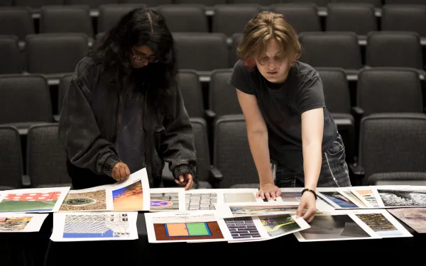 Conference attendees look at photo prints.