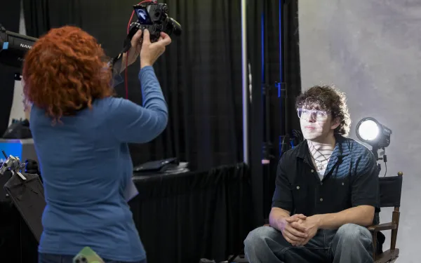 One person takes a photo of another.