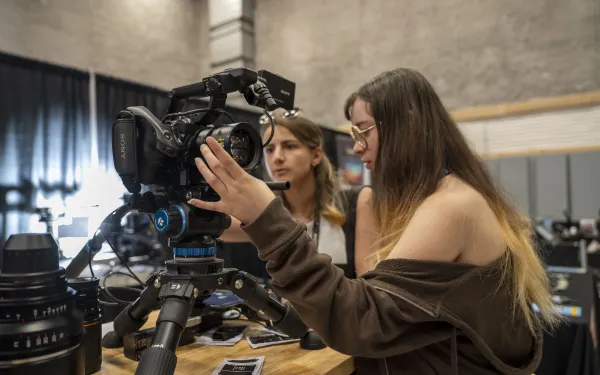 Conference attendees check out a high-end camera system.