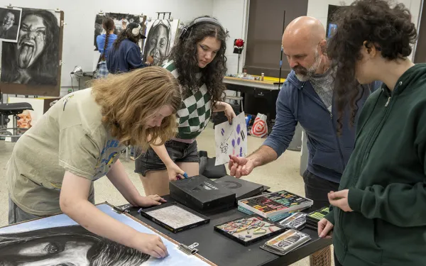 A group of students gather materials in the RIT drawing studio.