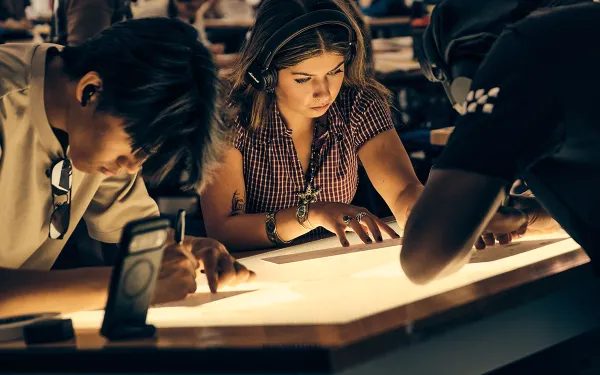 RIT students draw designs on paper during their 2D Design course.
