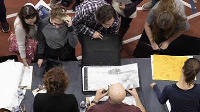 An overhead photo of students receiving portfolio reviews.
