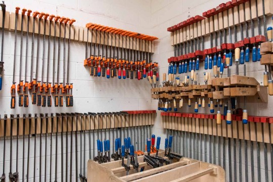 Clamps hanging from the wall in the CNC room