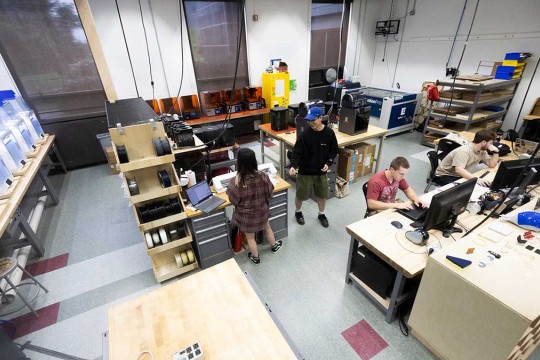 A high view of student employees working in the Fab Lab.