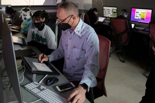 Professor Chad Grohman teaches illustration in a computer lab.
