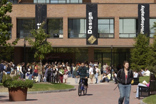 a picture of RIT students outside with banners hanging on a building
