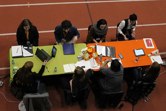 People studying at tables in gym