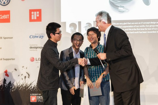 People accepting award on stage