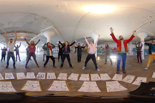 Students pose for 360 video with arms above their heads.