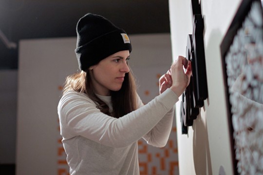 Person handing word on wall