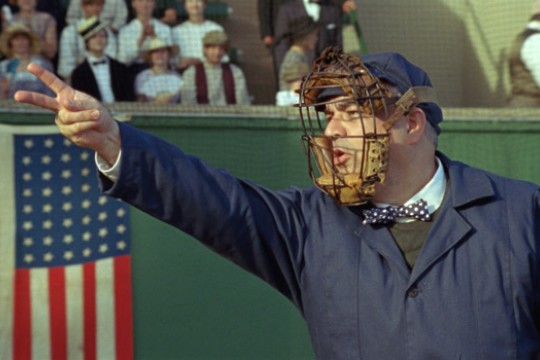Baseball player making hand signal toward field